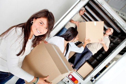 Staff carrying furniture with insurance and safety measures